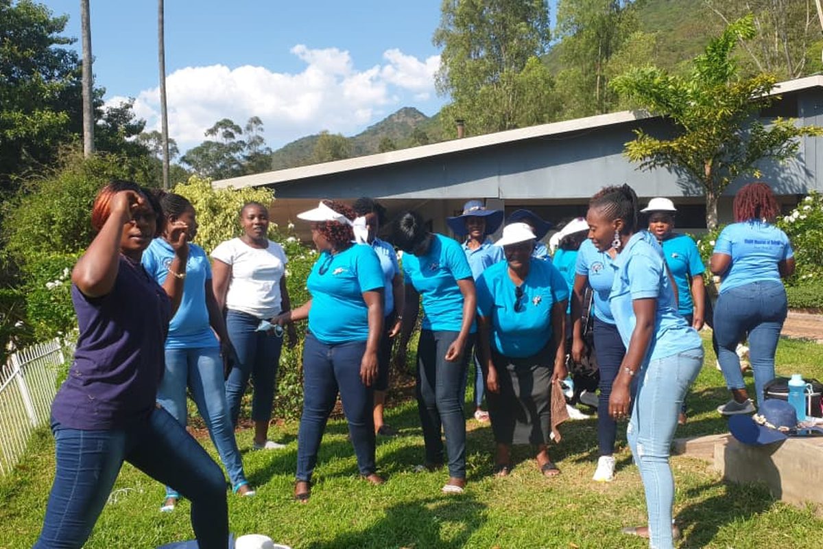 Great Potential Ladies members gathered outdoors in matching blue shirts