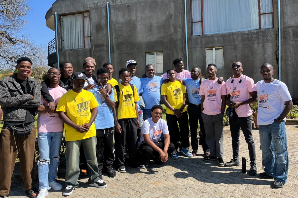 Youth conference delegates in matching T-shirts outside the venue