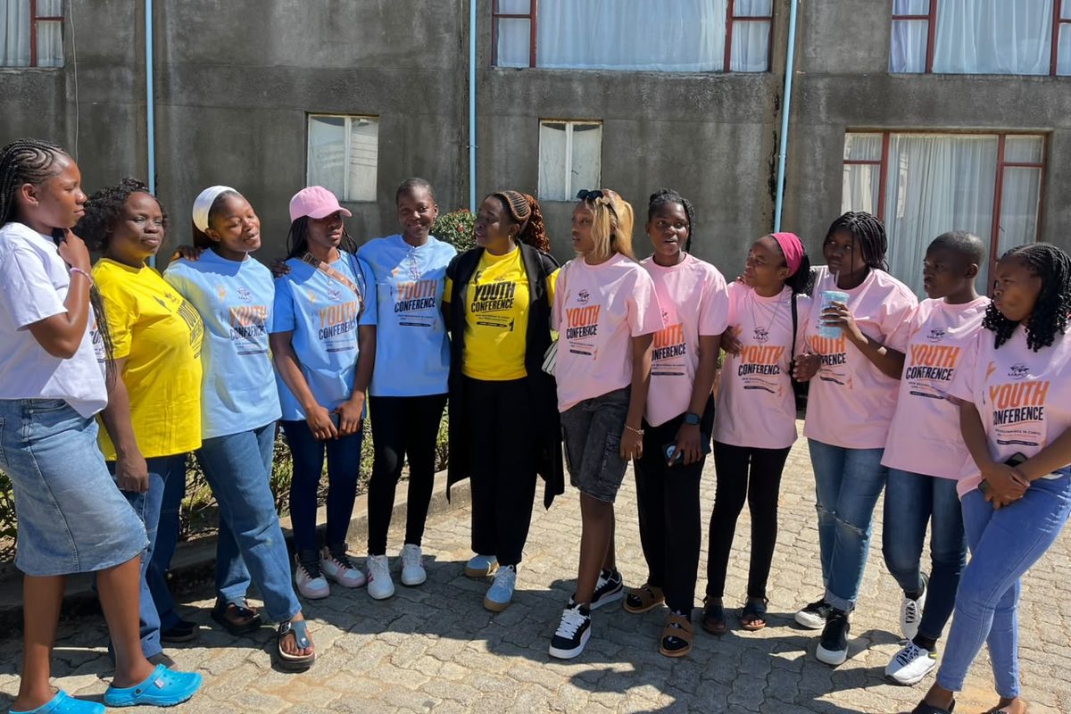Young women at the youth conference standing arm in arm