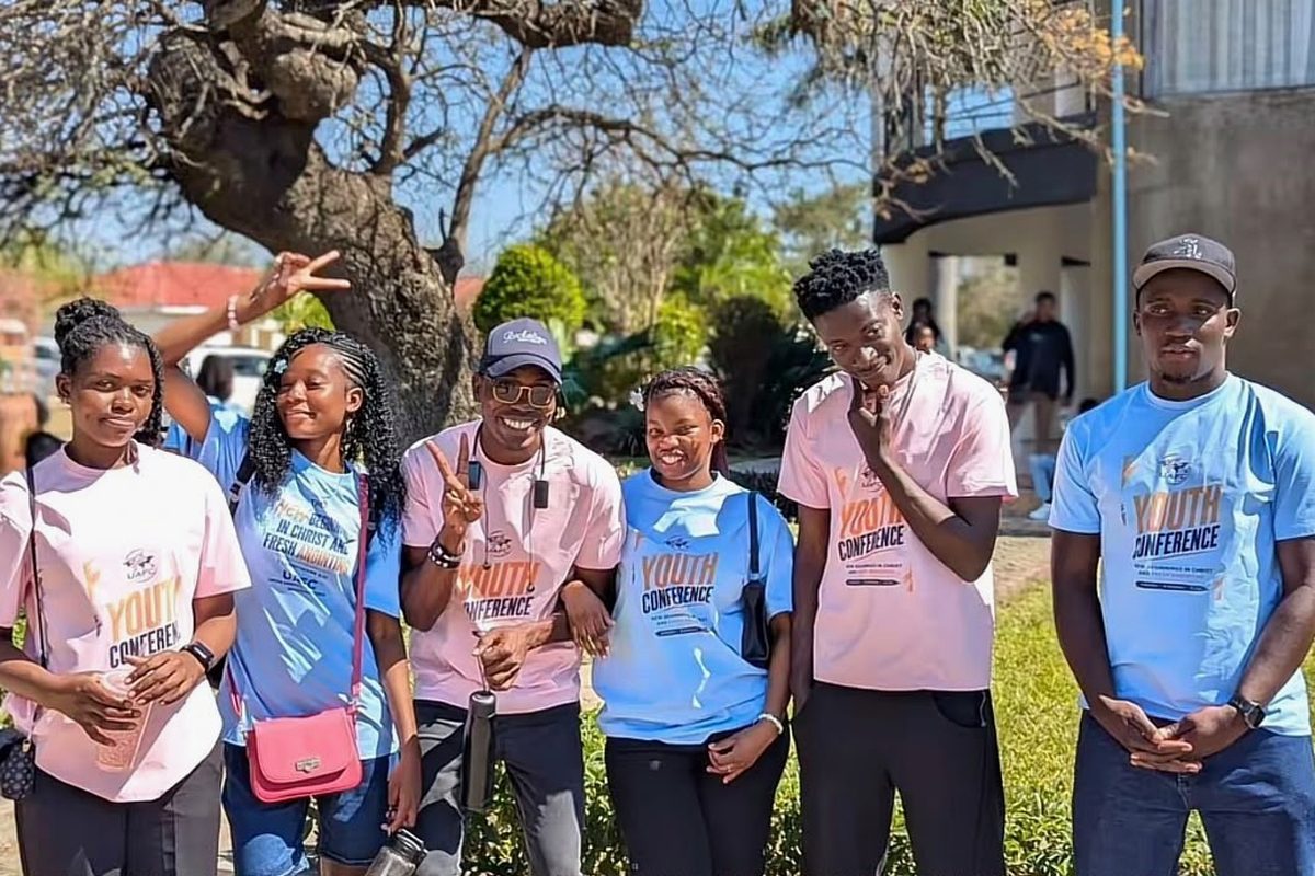 Smiling youth conference delegates posing outdoors